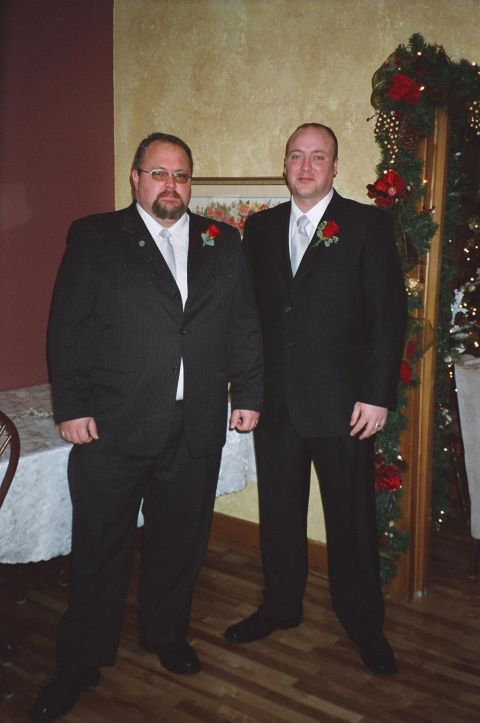 1984 Ford Bronco - Two men in formal attire pose for a photo indoors, with festive decorations in the background.