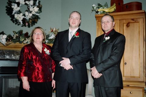 1984 Ford Bronco - A family poses for a photograph, likely at a wedding or formal event, with decorative elements in the background.