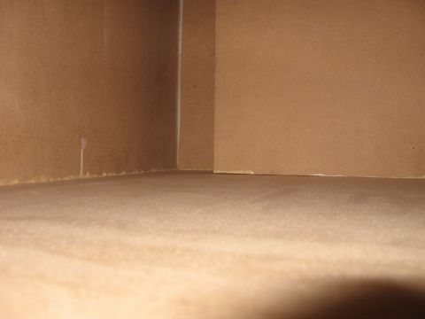 1992 Ford Crown Victoria - Interior corner of a room with brown walls and floor, with a visible seam where the walls meet.