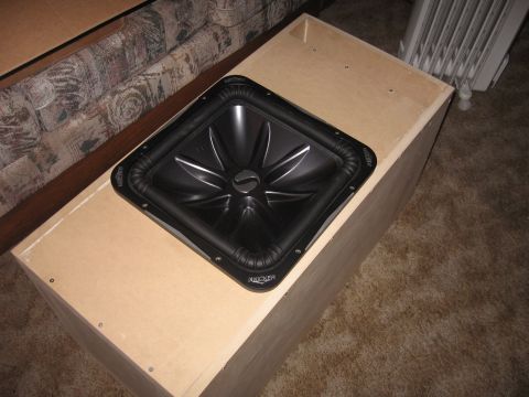 1992 Ford Crown Victoria - Custom subwoofer box with Kicker speaker, placed on carpet next to a couch.