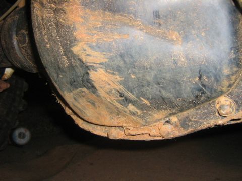 1986 Ford Bronco - The rear differential housing is covered in dirt and shows signs of rust along its lower edge.