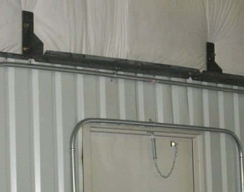 1986 Ford Ranger - Interior view of a structure with a metal track system and corrugated walls.