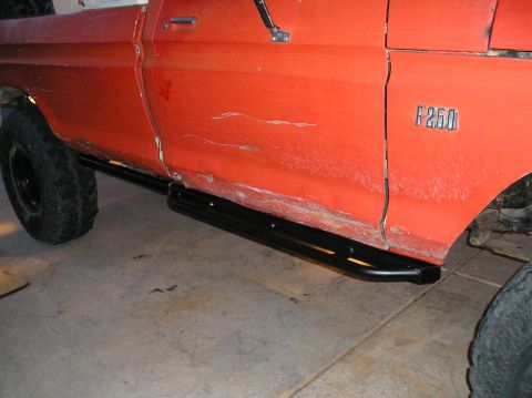 1986 Toyota Hilux - Side view of an orange Ford F-250 pickup truck, running boards and visible F-250 badging.