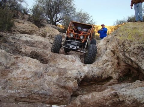 1987 Suzuki Samurai - Off-road buggy tackling a challenging rocky terrain.