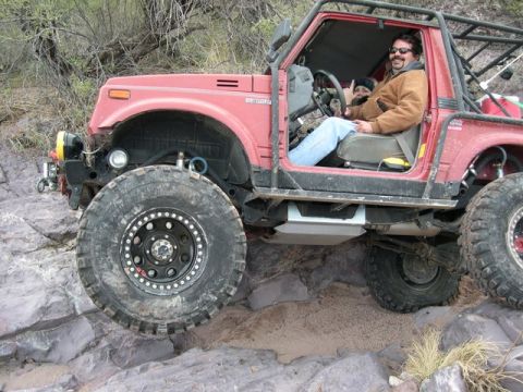1987 Suzuki Samurai - Modified 1987 Suzuki Samurai navigating a rocky trail with a driver and passenger inside.
