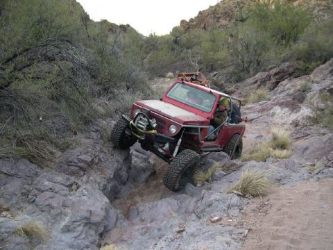 1987 Suzuki Samurai - A modified 1987 Suzuki Samurai tackles a challenging rocky trail in a desert canyon.