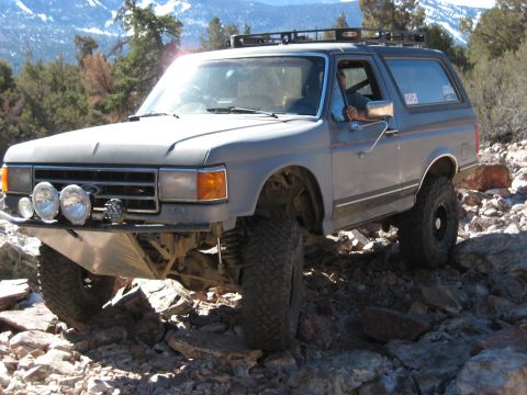 1996 Ford Bronco - This modified Ford Bronco navigates a challenging rocky trail, its off-road capabilities.