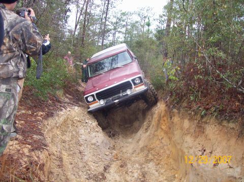 1978 Ford Bronco - A 1978 Ford Bronco tackles a challenging off-road trail, with onlookers documenting the action.