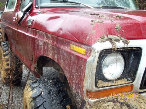 1978 Ford Bronco - Mud-covered 1978 Ford Bronco with off-road tires, likely after an off-road excursion.