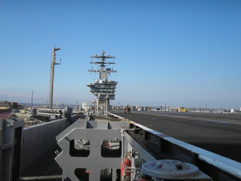 1989 Ford F-250 - View from an aircraft carrier deck shows the vast expanse of the flight deck under a clear blue sky.