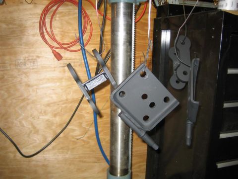 1987 Suzuki Samurai - Several gray suspension parts are suspended by wires, possibly awaiting installation or finishing.