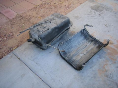 1987 Suzuki Samurai - Fuel tank and skid plate removed from a vehicle.