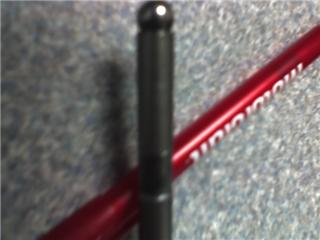 1991 Ford Mustang - A close-up of a black rod and a red pen with text on it.