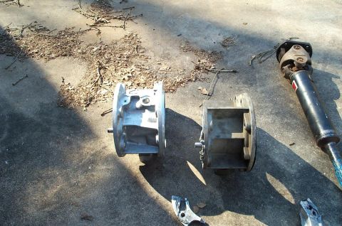 1996 Ford Bronco - Two disassembled automotive housings and a driveshaft are visible on the ground.