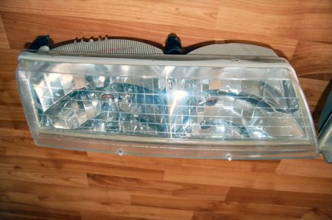 1985 Mercury Grand Marquis - Headlight assembly with a clear, faceted lens, likely for a vehicle part restoration project.