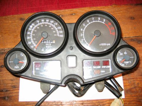1985 Ford LTD Crown Victoria - This motorcycle instrument cluster features a speedometer, tachometer, fuel gauge, and oil temperature gauge, along with indicator lights.