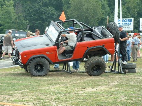 1968 Ford Bronco - Modified 1968 Ford Bronco on display at an event, with a spare tire mounted on the back.