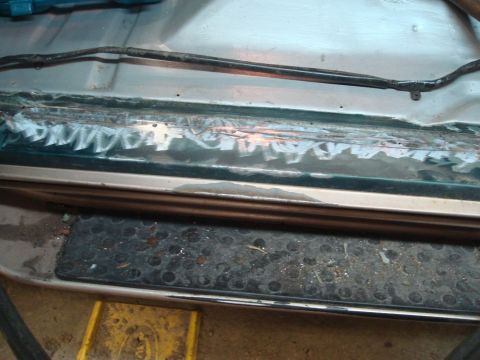 1996 Ford Bronco - Close-up of a 1996 Ford Bronco's door jam, showing evidence of repair and exposed wiring.