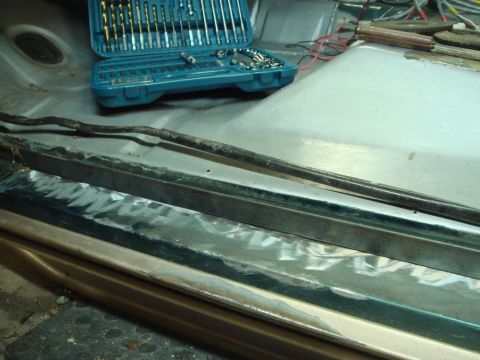 1996 Ford Bronco - Door jam repair in progress, with a drill bit set and electrical wiring visible in the background.