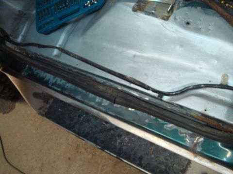 1996 Ford Bronco - Close-up of a 1996 Ford Bronco's door jam, showing evidence of rust and repair.