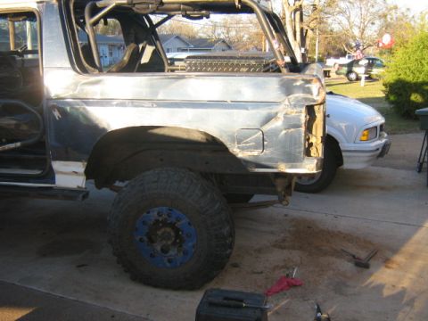 1986 Ford Bronco - This heavily modified Ford Bronco shows significant body damage and custom off-road modifications.