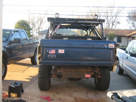 1986 Ford Bronco - Rear view of a modified 1986 Ford Bronco, a custom roll cage and off-road lighting.