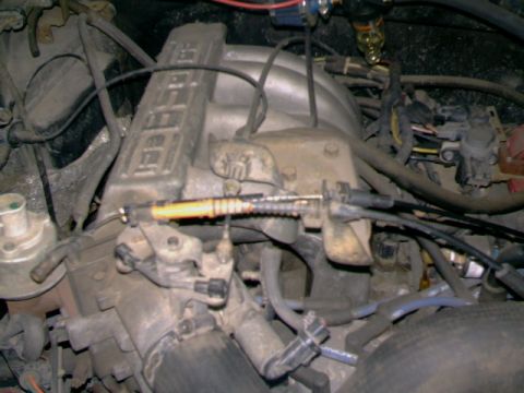 1989 Ford Bronco - Engine bay detail showing throttle cable and intake manifold assembly.