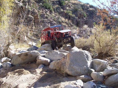 1981 Ford F-150 - A custom-built off-road buggy tackles a challenging rocky terrain in a desert-like environment.