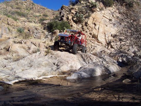1981 Ford F-150 - Custom off-road buggy tackles a challenging rocky terrain in a desert landscape.