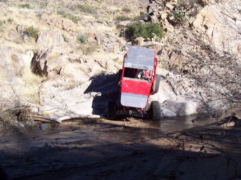 1981 Ford F-150 - Custom buggy tackles a rocky stream crossing in a desert landscape.