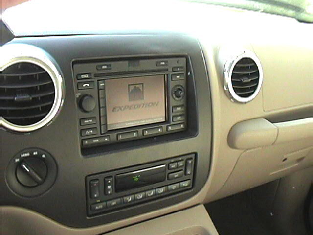 Ford Expedition center dash with nav screen showing EXPEDITION logo, climate controls, and round air vents