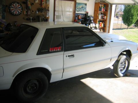 1992 Ford Mustang - White 1992 Ford Mustang coupe parked in a garage with HRE decals.