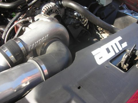 1992 Ford Crown Victoria - Close-up of an engine bay a Paxton supercharger and a sticker on the plastic cover.