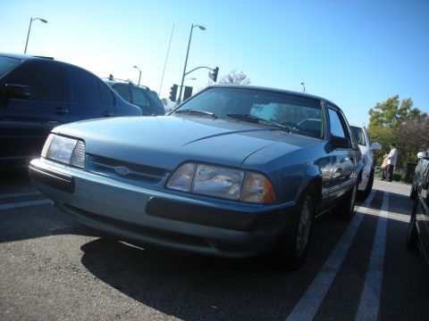 1992 Ford Crown Victoria - A blue sedan is parked in a lot, with other vehicles visible around it.