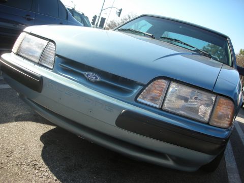 1992 Ford Crown Victoria - Front view of a blue Ford Mustang, showing the grille and headlights.