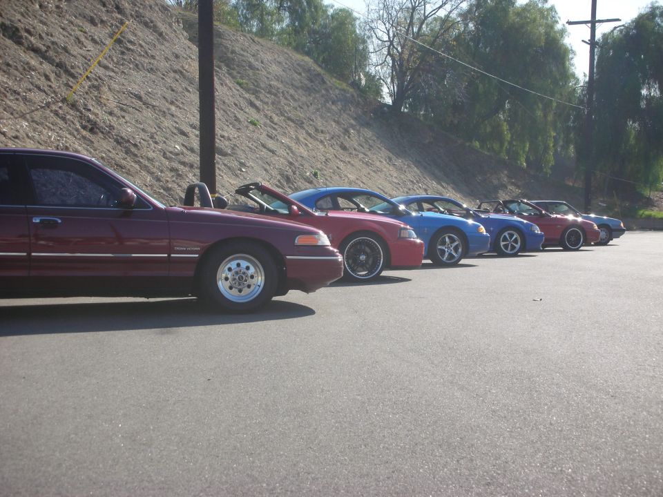 Maroon 1992 Ford Crown Victoria parked next to several other cars