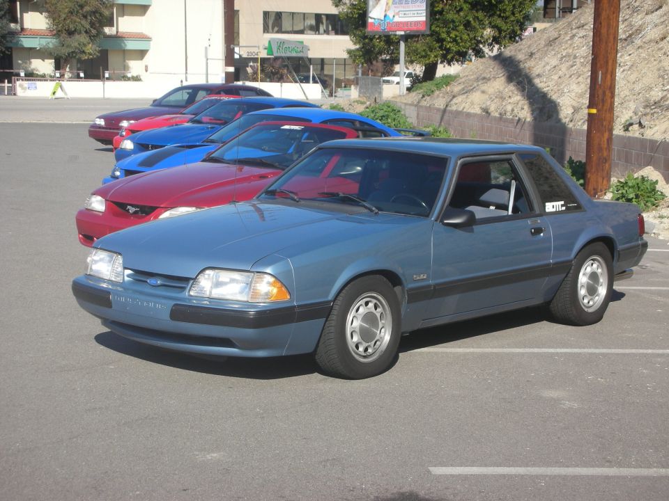Blue coupe with a black trim and silver wheels parked in a lot