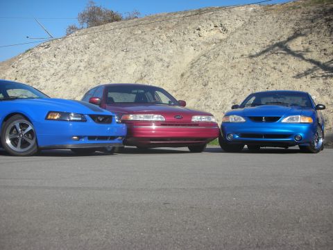 1992 Ford Crown Victoria - Three generations of Ford Mustangs are parked alongside a Ford Crown Victoria.