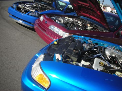 1992 Ford Crown Victoria - Multiple vehicles displayed with their engines exposed at a car meet.