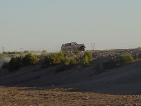 1992 Ford Bronco - A 1992 Ford Bronco navigates a dusty, arid landscape.