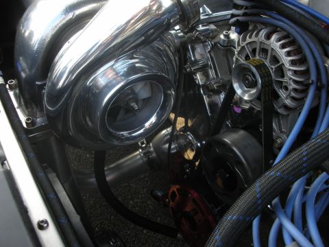 1998 Ford Crown Victoria - Close-up view of a custom engine build with a polished turbocharger and visible wiring.