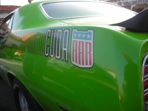 1998 Ford Crown Victoria - A bright green Plymouth Barracuda is shown from the rear quarter panel, a prominent 'CUDA AAR' decal.