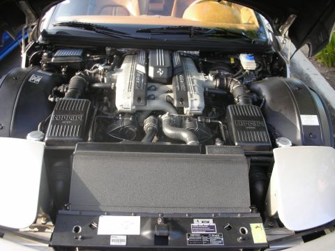 1998 Ford Crown Victoria - The engine bay reveals twin V8 engines, a hallmark of performance engineering, with prominent Ferrari branding visible.