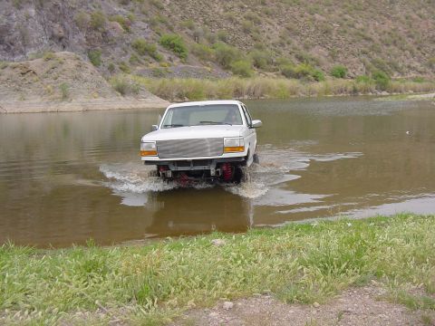 1992 Ford Bronco - White 1992 Ford Bronco fording a body of water.