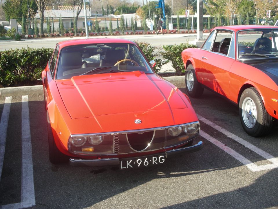 Orange Alfa Romeo Junior Zagato coupe with Dutch plate parked beside another Alfa