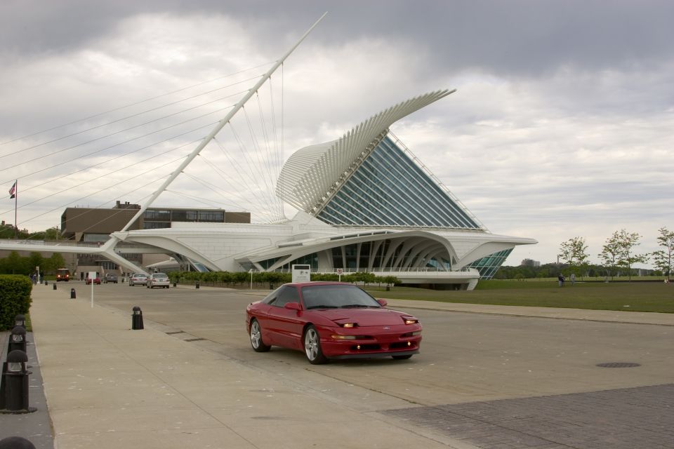 Red sport coupe in front of the Milwaukee Art Museum