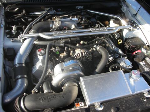 1998 Ford Crown Victoria - Close-up view of a modified engine bay with custom components and visible wiring.