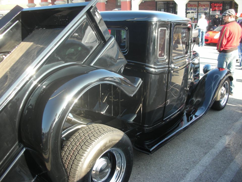 Side view of black vintage hot rod sedan with whitewall tires