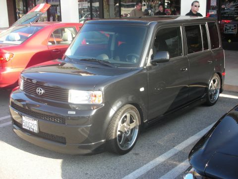1998 Ford Crown Victoria - A dark gray Scion xB is parked in a lot with other vehicles visible.
