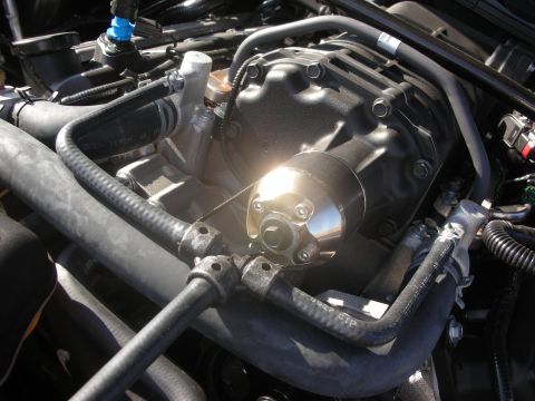 1998 Ford Crown Victoria - Engine bay detail showing a supercharger assembly with various hoses and connections.